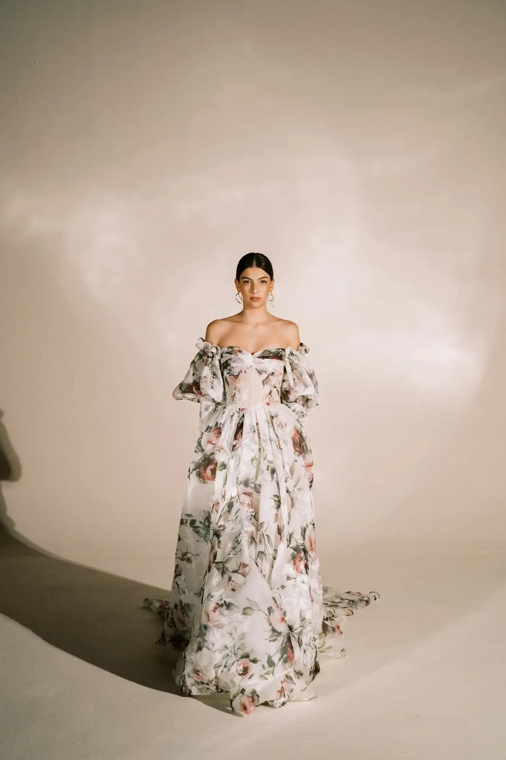 Model is wearing an off the shoulder a-line floral wedding dresses 