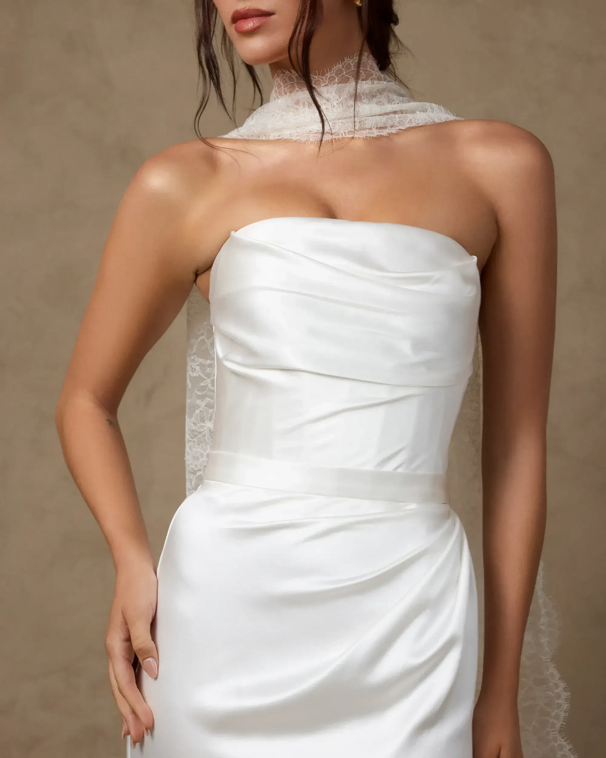 model is wearing a strapless sheath bridal gown