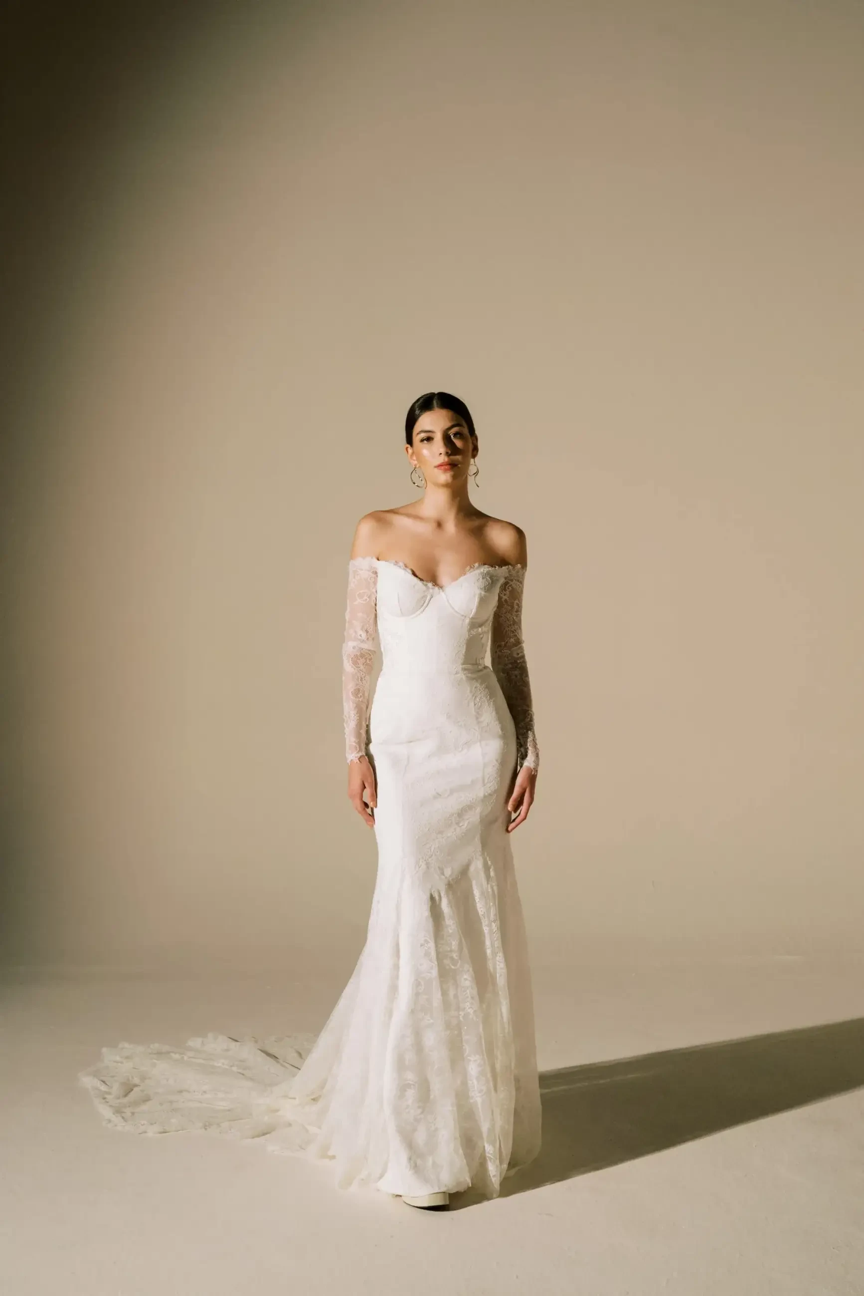 model is wearing an off the shoulder sweetheart neckline wedding dress