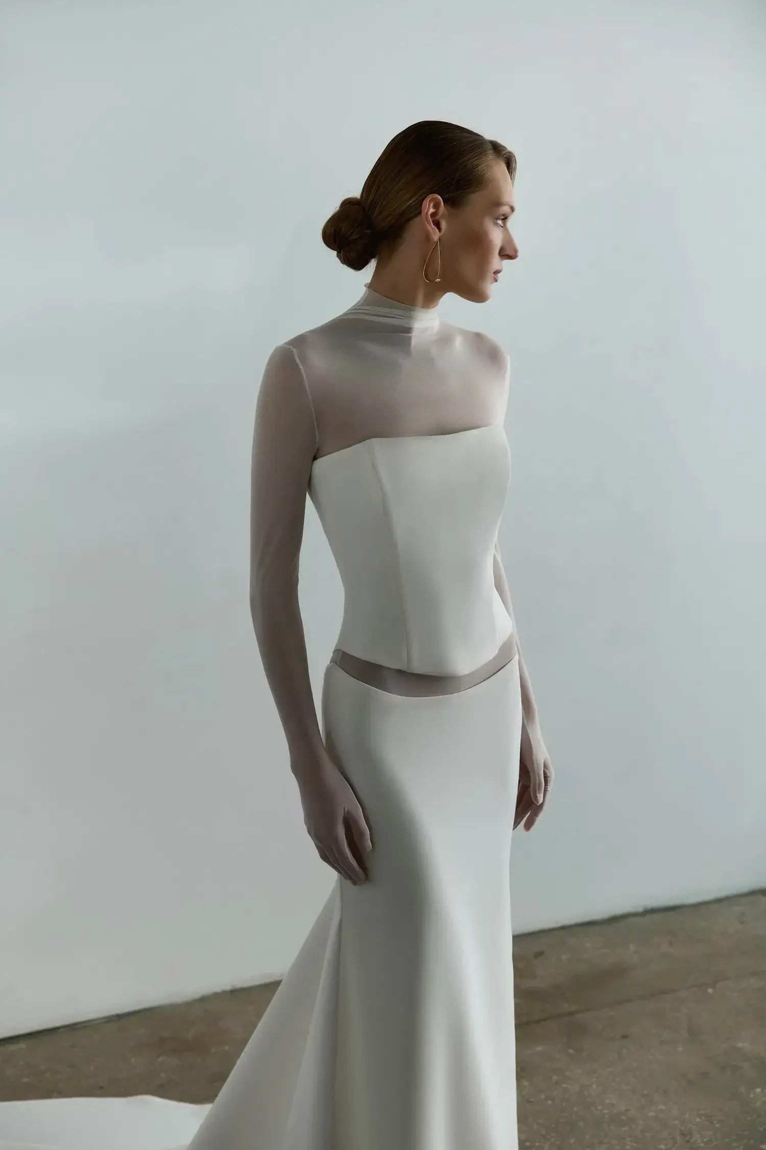 model is wearing a three piece wedding dress